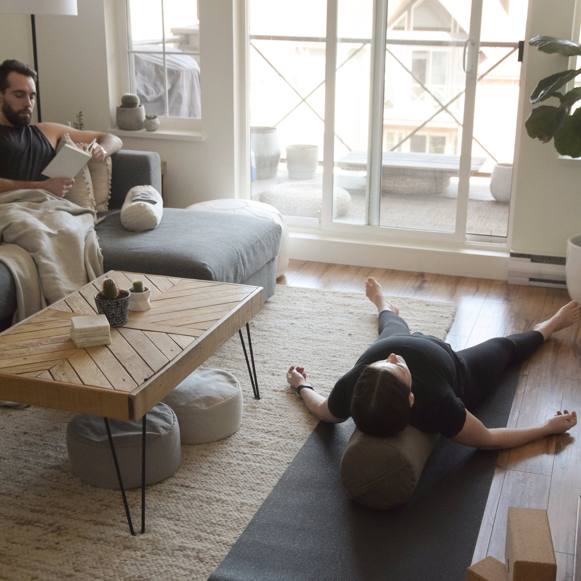 woman laying on the cylindrical bolster